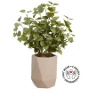 Artificial eucalyptus foliage in a beige vase