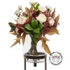 Artificial fall bouquet in a standing glass vase