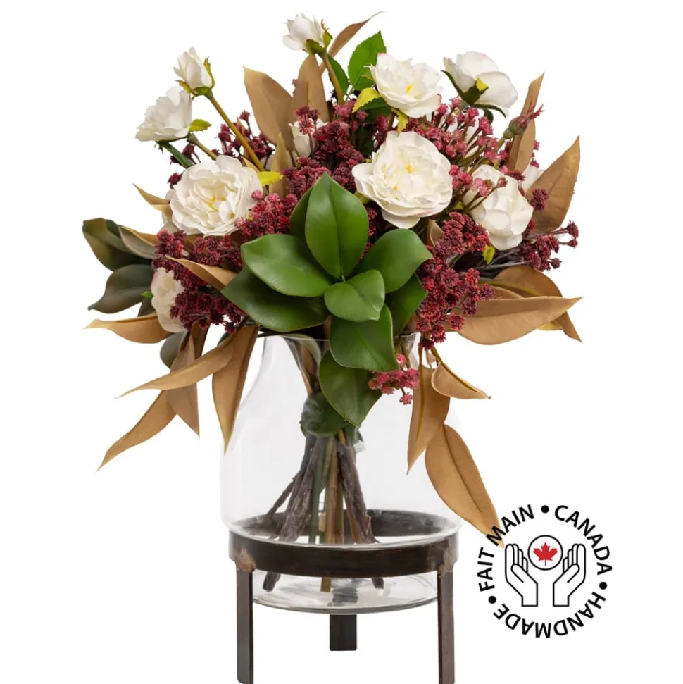 Artificial fall bouquet in a standing glass vase