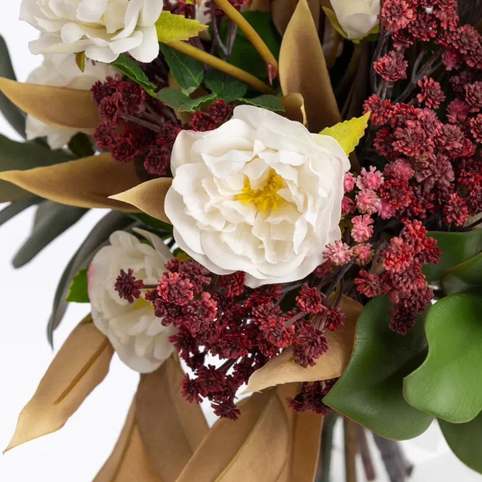 Artificial fall bouquet in a standing glass vase