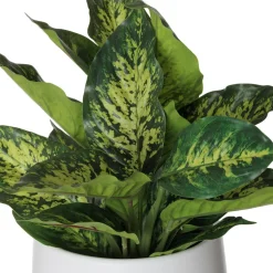 Artificial green aglaonema in a white pot