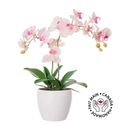 Artificial pink orchid in a white pot
