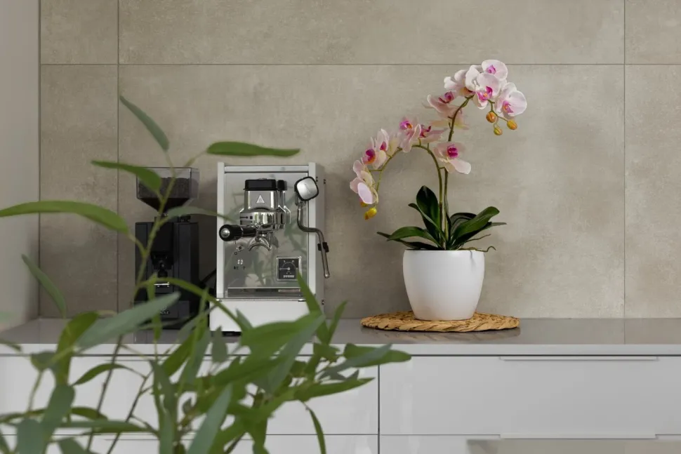 Artificial pink orchid in a white pot