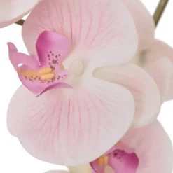 Artificial pink orchid in a white pot