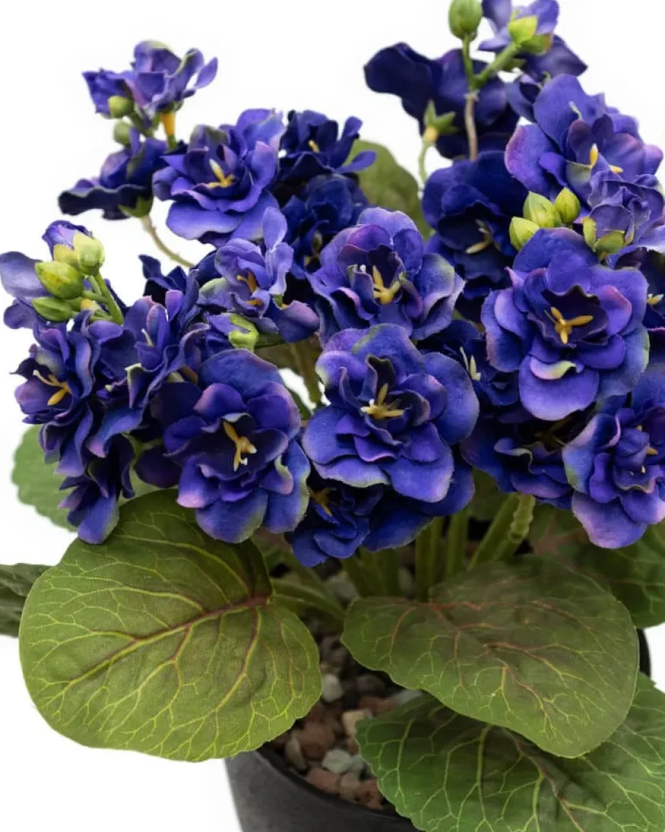 Artificial purple spring flower bouquet in a black pot
