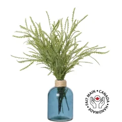 Artificial staghorn fern in a glass vase