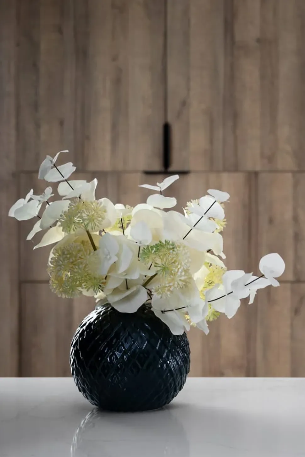 Artificial white eucalyptus in a round vase