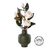 Artificial white magnolia flowers in a green vase