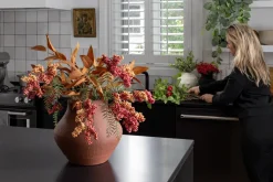 Berry and eucalyptus arrangement in a vase