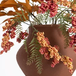 Berry and eucalyptus arrangement in a vase