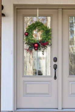 Berry and red ornament decorated Christmas wreath