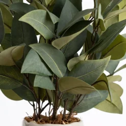 Bouquet of artificial eucalyptus in a pink vase