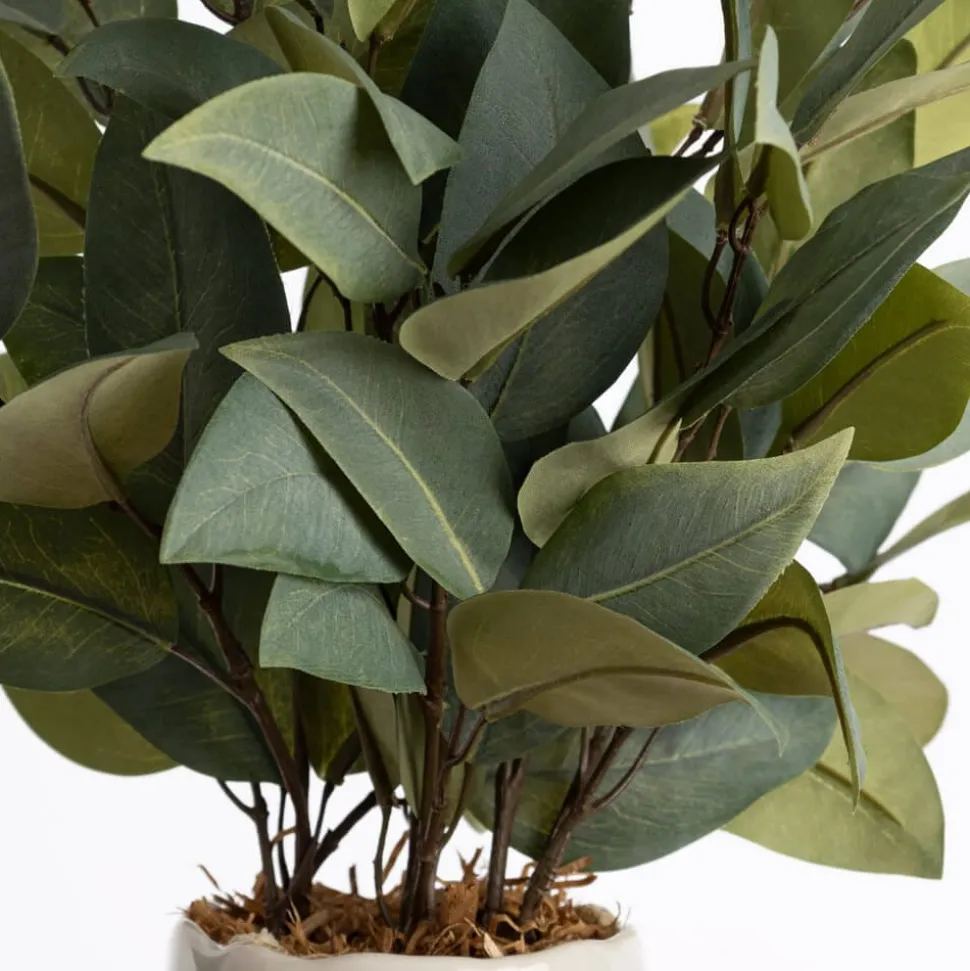 Bouquet of artificial eucalyptus in a pink vase