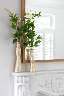 Duo of small tabletop vases with artificial greenery