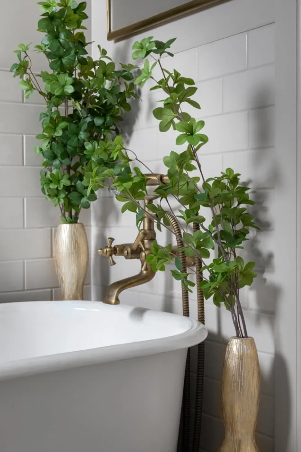Duo of tall floor vases with artificial greenery