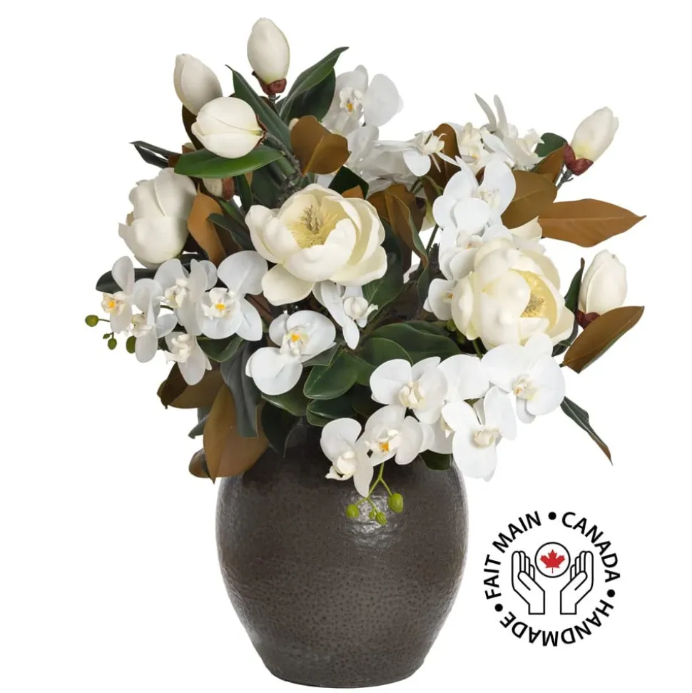 Magnolia and orchid arrangement in a vase