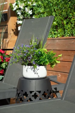 Outdoor centerpiece of small purple flowers and mixed foliage, 14 x 16