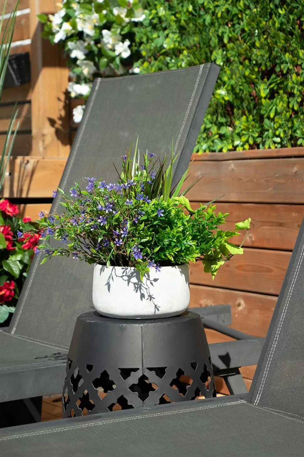 Outdoor centerpiece of small purple flowers and mixed foliage, 14 x 16"