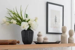 Small white flower bouquet in a black vase